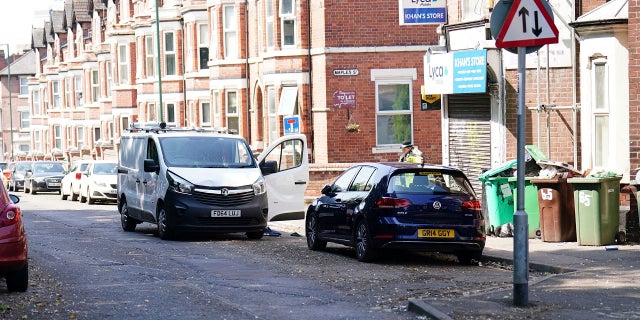 Police inspect white van in Nottingham, England