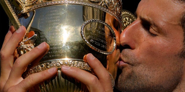 Novak Djokovic kisses trophy