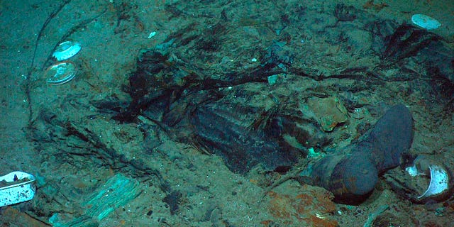 Remains of a coat and boots in the mud on the sea bed near the Titanic's stern