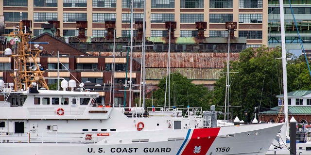 Two US Coast Guard vessels sit in port in Boston Harbor across from the US Coast Guard Station Boston in Boston, Massachusetts