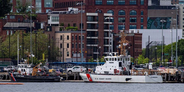 Two US Coast Guard vessels sit in port in Boston Harbor across from the US Coast Guard Station Boston in Boston, Massachusetts