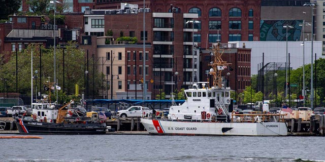 Two US Coast Guard vessels sit in port in Boston Harbor across from the US Coast Guard Station Boston in Boston, Massachusetts
