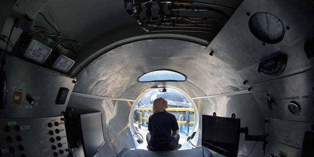 A woman sits inside an OceanGate submersible