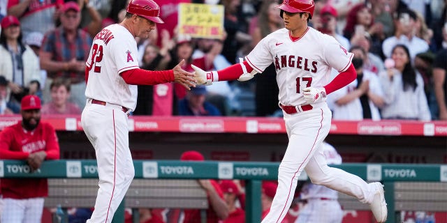 Shohei Ohtani and Bill Haselman celebrate