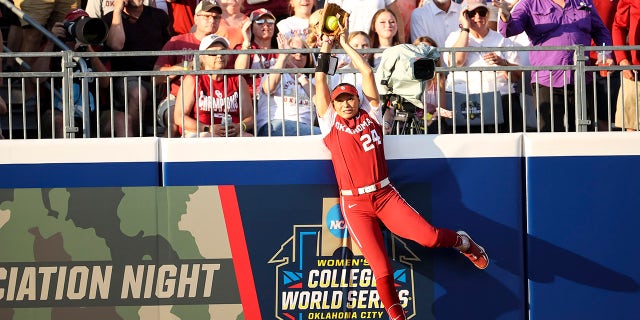 Jayda Coleman hits the wall to catch the ball