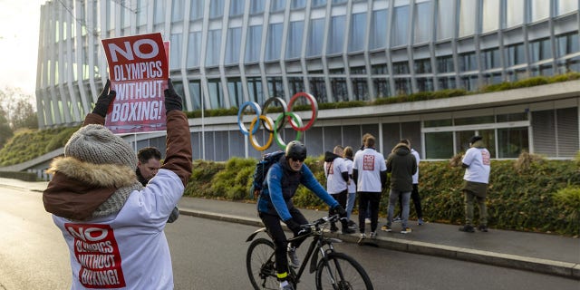 A woman holds poster in support of boxing