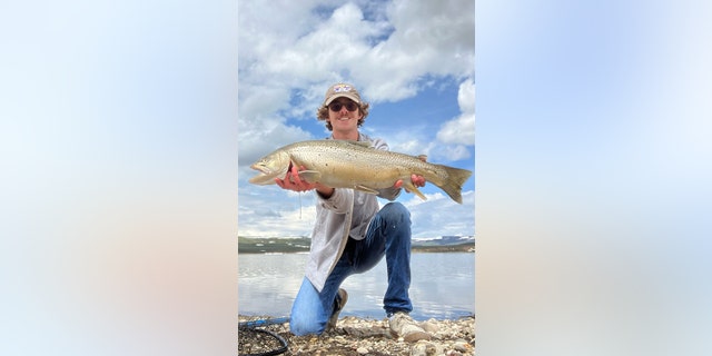 Owen Schaad holds up tiger trout