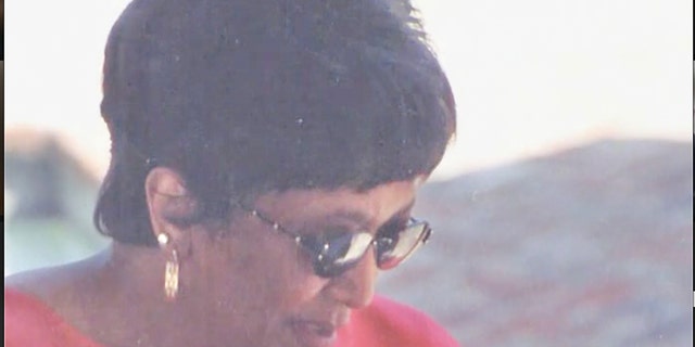 Minnie Smith wearing sunglasses and a coral blouse