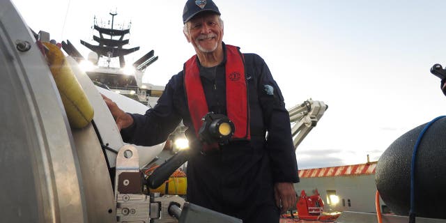 Paul-Henry (PH) Nargeolet poses for a photo alongside OceanGate's Titan submersible