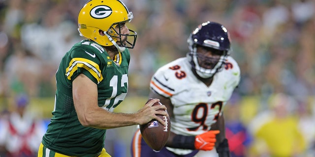 Aaron Rodgers is pursued by Justin Jones