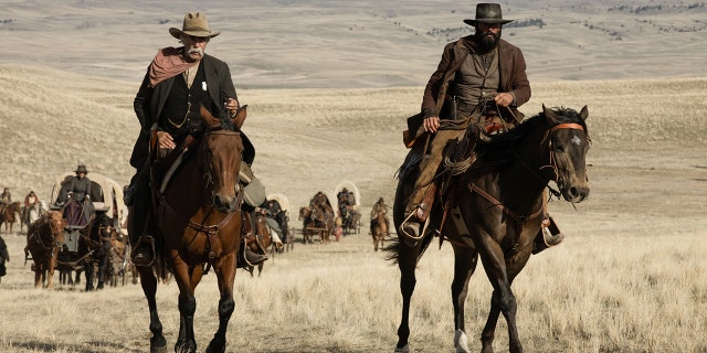 Sam Elliott and Tim McGraw riding horses in Western wear