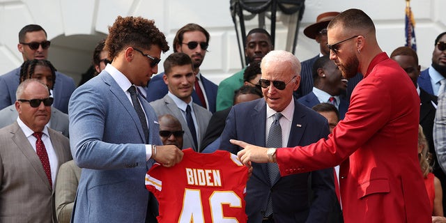 Patrick Mahomes holds Joe Biden's jersey