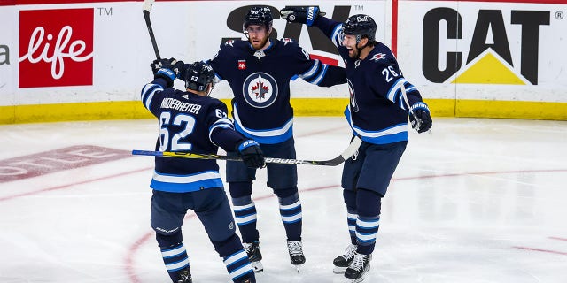 Nino Niederreiter, Pierre-Luc Dubois, and Blake Wheeler celebrate goal