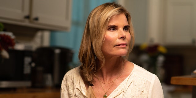A close up of Mariel Hemingway wearing a white blouse