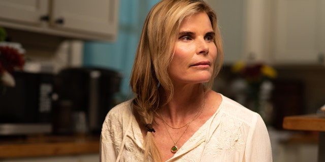 A close-up of Mariel Hemingway wearing a white blouse