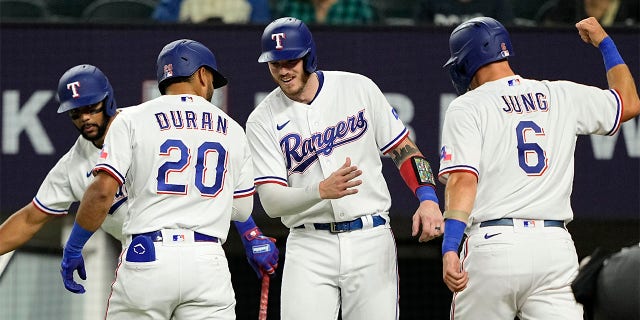 Ezequiel Duran celebrates with Leody Taveras and Josh Jung