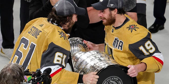 Mark Stone hands cup to Reilly Smith