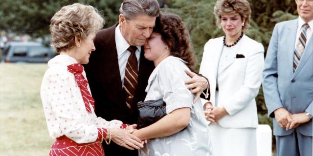 Ronald Reagan comforting supporting