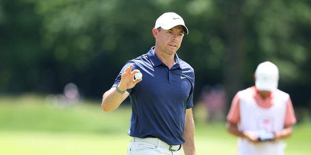 Rory McIlroy waves to crowd