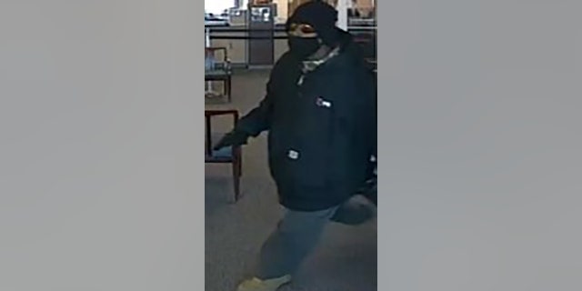 suspect holding gun