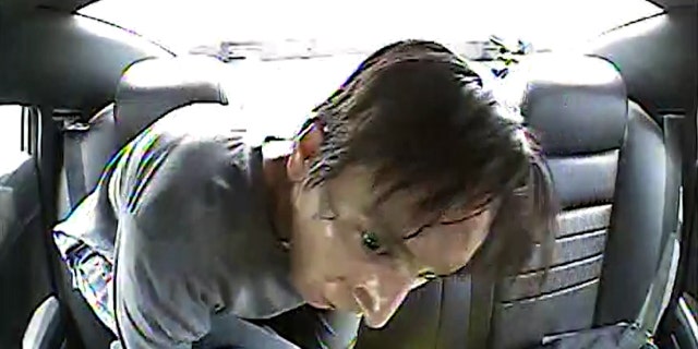 Colorado suspect Anthony Alphonso Sanchez III wriggling out of handcuffs in the back of a police car