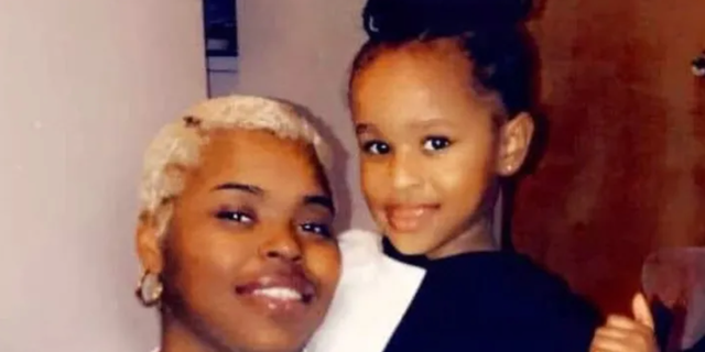 young mother smiling holding her daughter
