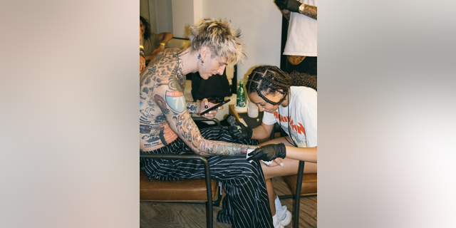 Machine Gun Kelly with daughter tattoo