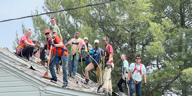 Teenagers fixing roof