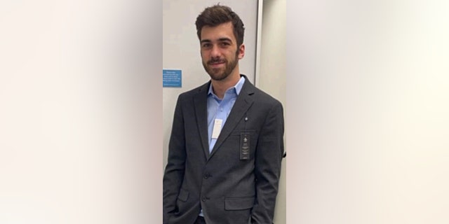 Noah Enos wearing a suit