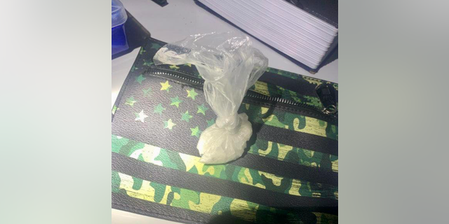 Meth bag on top of camo-colored US flag design bag