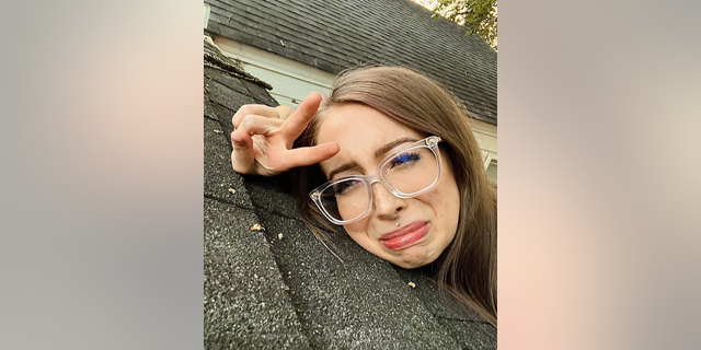 Arkansas woman posing with sad face on roof tiles