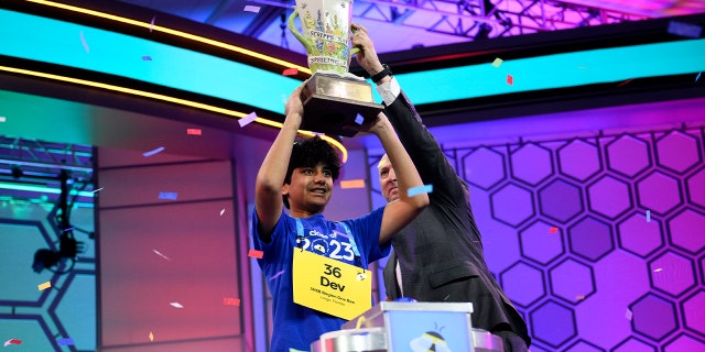 Dev Shah holding up trophy