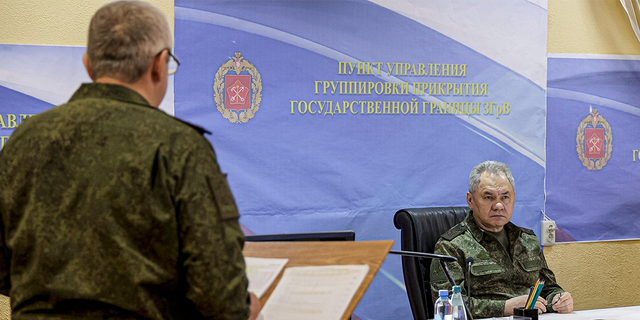 Sergei Shoigu listens to military leader