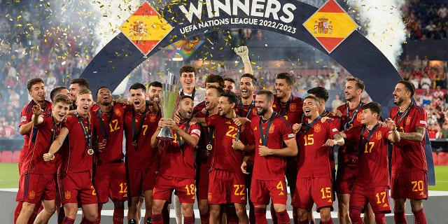 Spain players celebrate with trophy