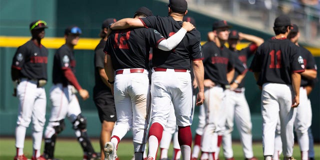 Tommy Troy and Steve Rodriguez walk in outfield