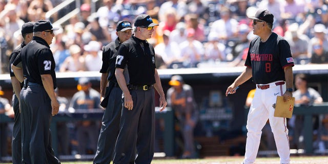 David Esquer talks with umpires