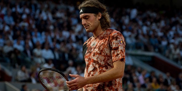 Stefanos Tsitsipas looks down