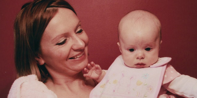 Beata Kowalski holding Maya as a baby