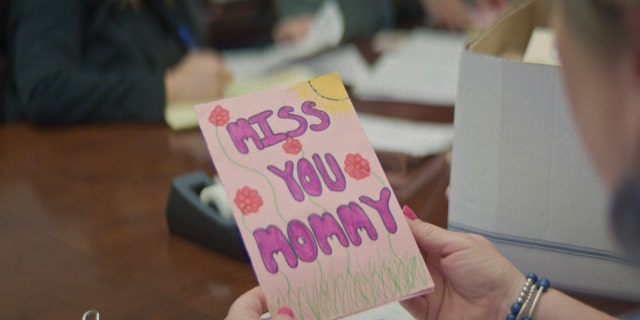 A letter from Maya to her mother that reads, "Miss you mommy," in pink lettering