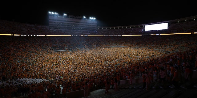 Tennessee Volunteers fans run across the field