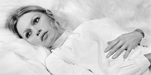 Brigitte Bardot in bed wearing white