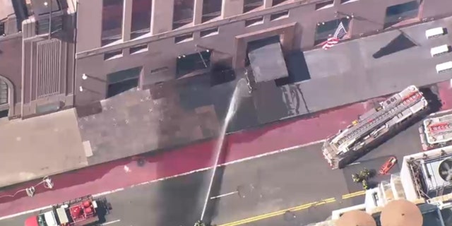 First responders dousing the Tiffany building where smoke was seen.