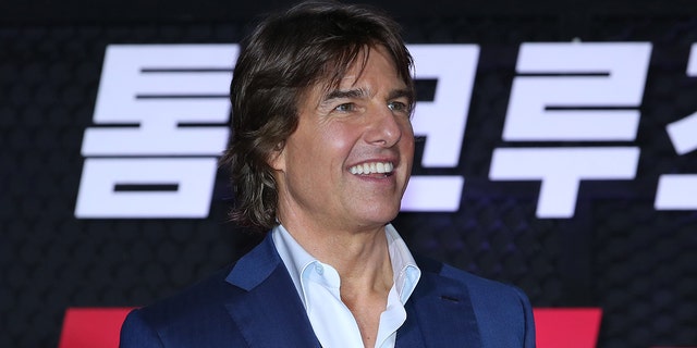 Tom Cruise smiling at a movie premiere