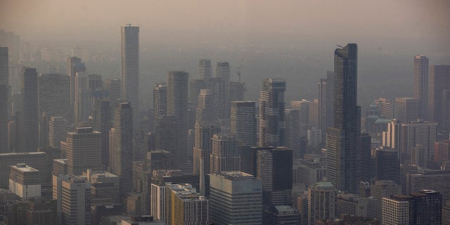 Canada warns of document 2023 wildfire destruction as touring smoke impacts tens of millions of Individuals 2 Toronto skyline seen with wildfire smoke