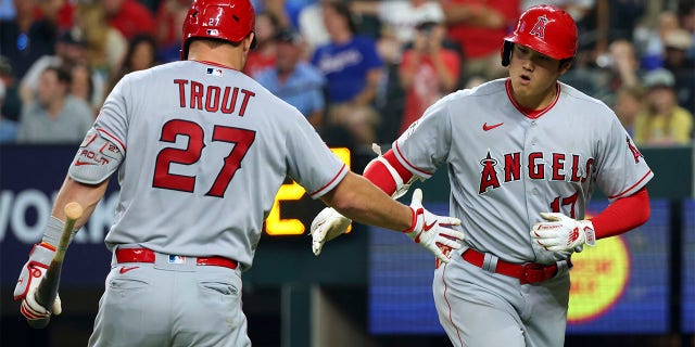 Shohei Ohtani celebrates with Mike Trout