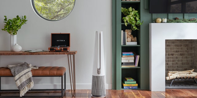 LG PuriCare AeroTower Air Purifying Fan with True HEPA and UVnano LED runs in an empty room.