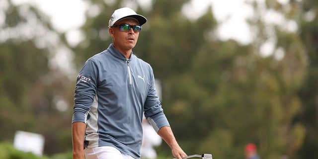 Rickie Fowler walks from the seventh tee