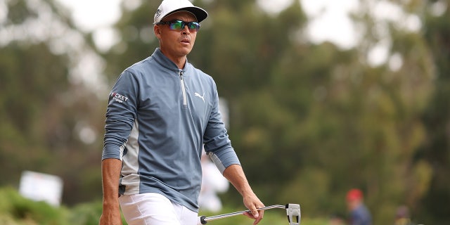 Rickie Fowler walks from the seventh tee