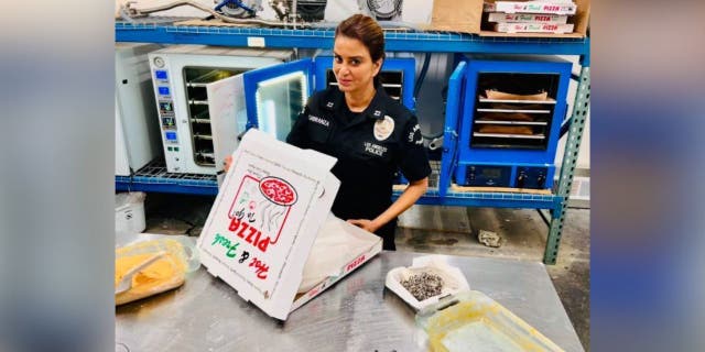 LAPD officer with pizza box
