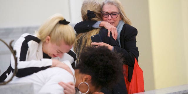 Victoria Valentino crying and hugging someone at Bill Cosby's trial